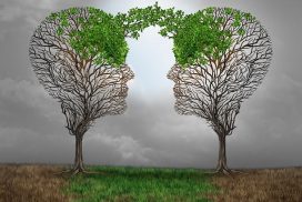 Dos árboles cuyas copas forman un rostro masculino y femenino están el uno frente al otro. Les une un puente de vegetación.